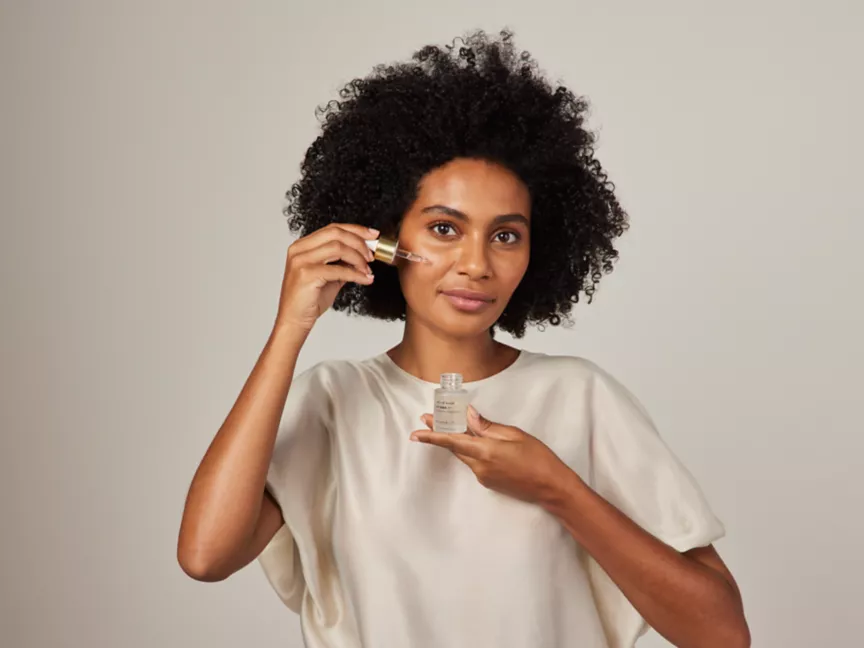 A woman using face serum