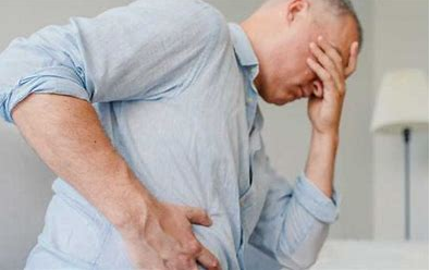 A man holding his stomach in pain.