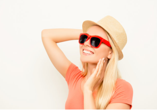A woman wearing sunglasses and a hat.